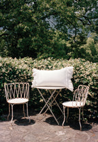 Crème ruffle pillowcase styled outdoors with layered scalloped detailing