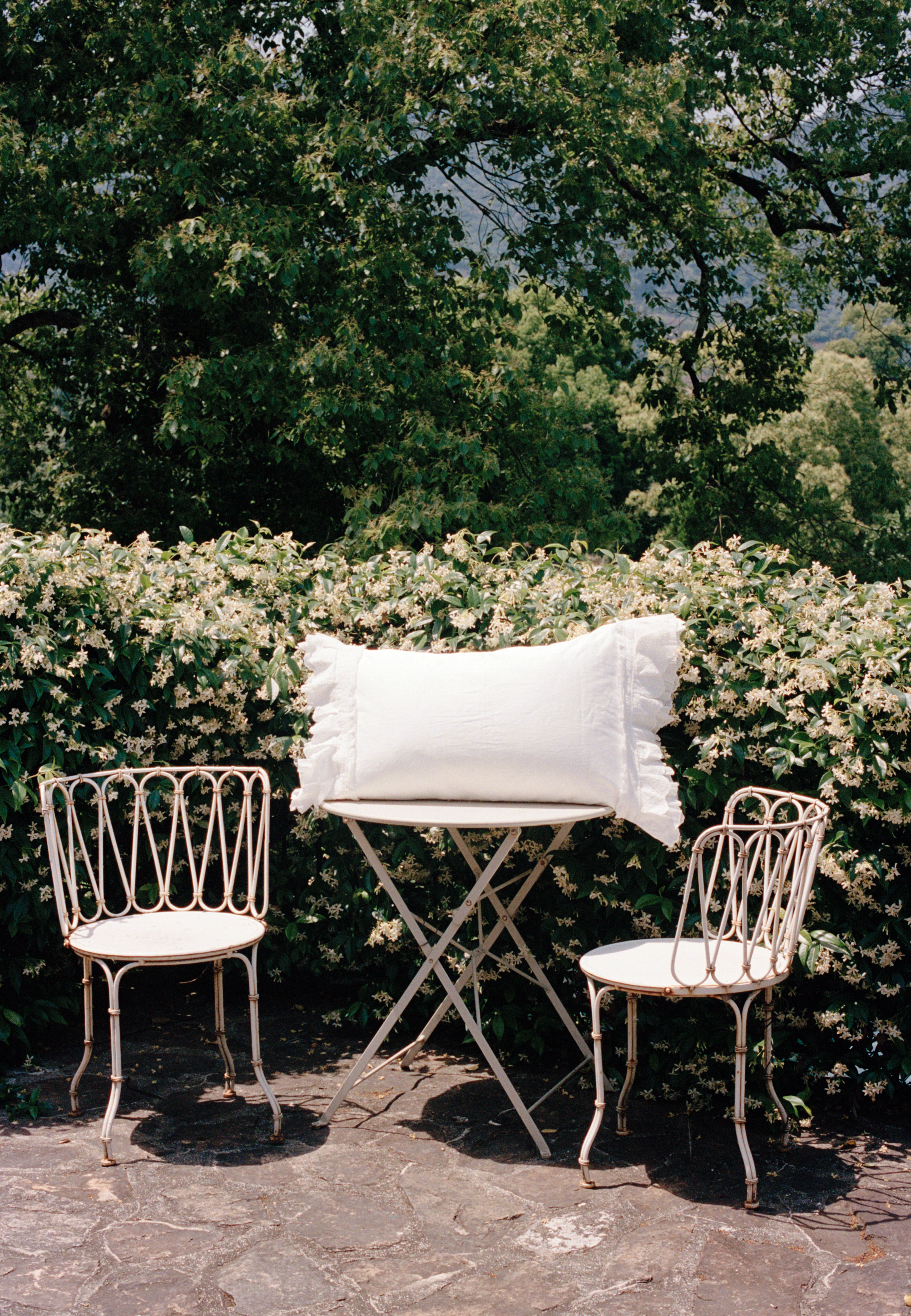 Crème ruffle pillowcase styled outdoors with layered scalloped detailing