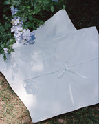 Laiterie cotton muslin keepsake bags with ribbon closures styled in a garden
