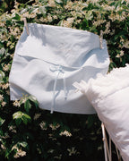 Laiterie cotton muslin bedding storage bag styled outdoors with soft bedding
