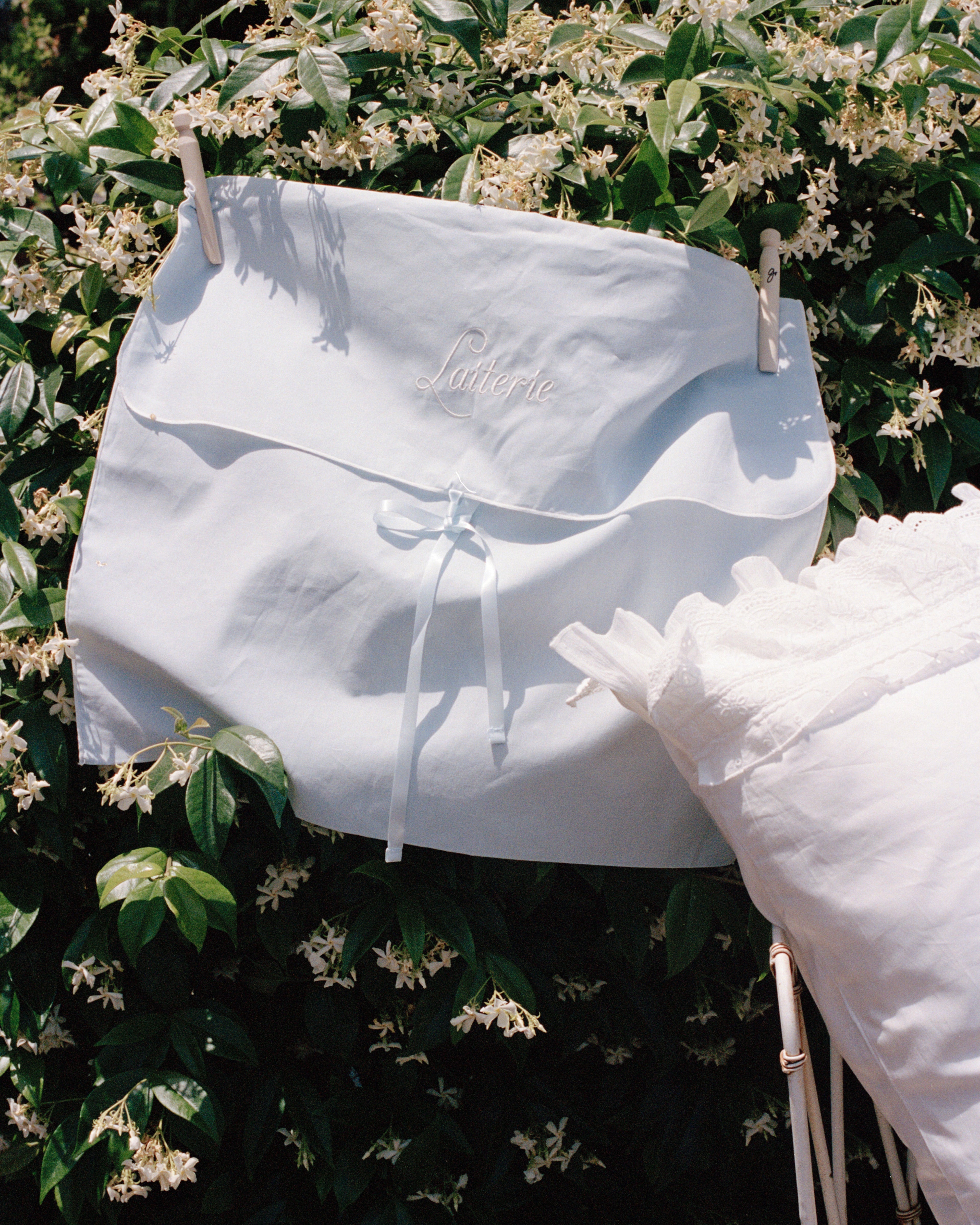 Laiterie cotton muslin bedding storage bag styled outdoors with soft bedding