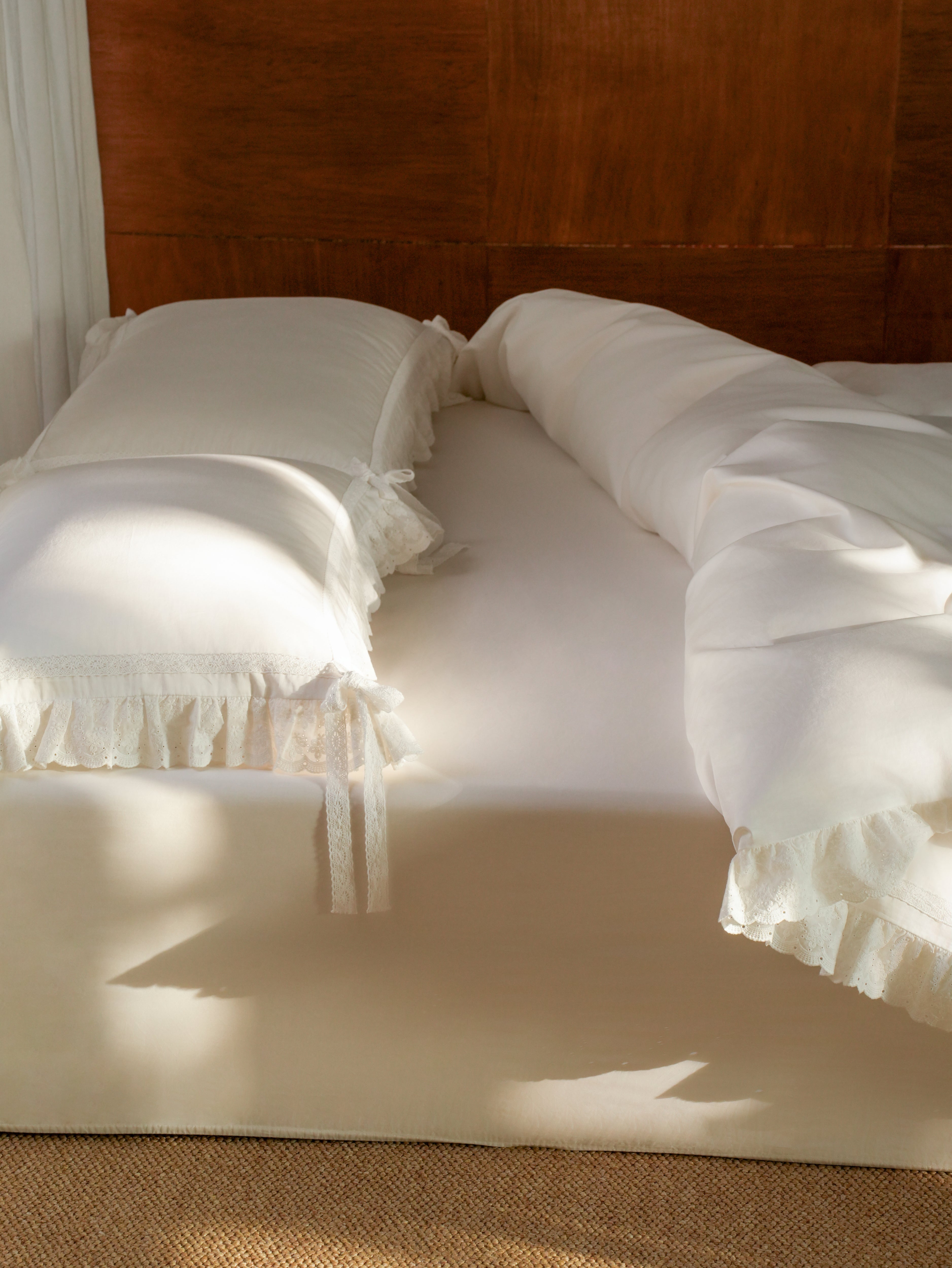 Lait fitted sheet styled on a bed with Chantilly ruffle bedding