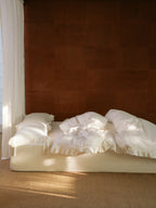 Chantilly ruffle bedding set styled in a warm sunlit bedroom
