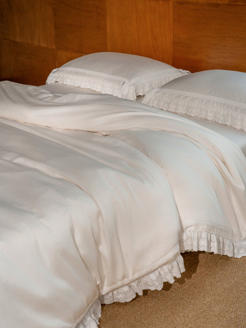 Chantilly ruffle duvet cover in ivory Egyptian cotton sateen on a styled bed