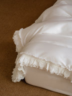 Close-up of layered ruffle edging on the Crème Egyptian cotton duvet cover