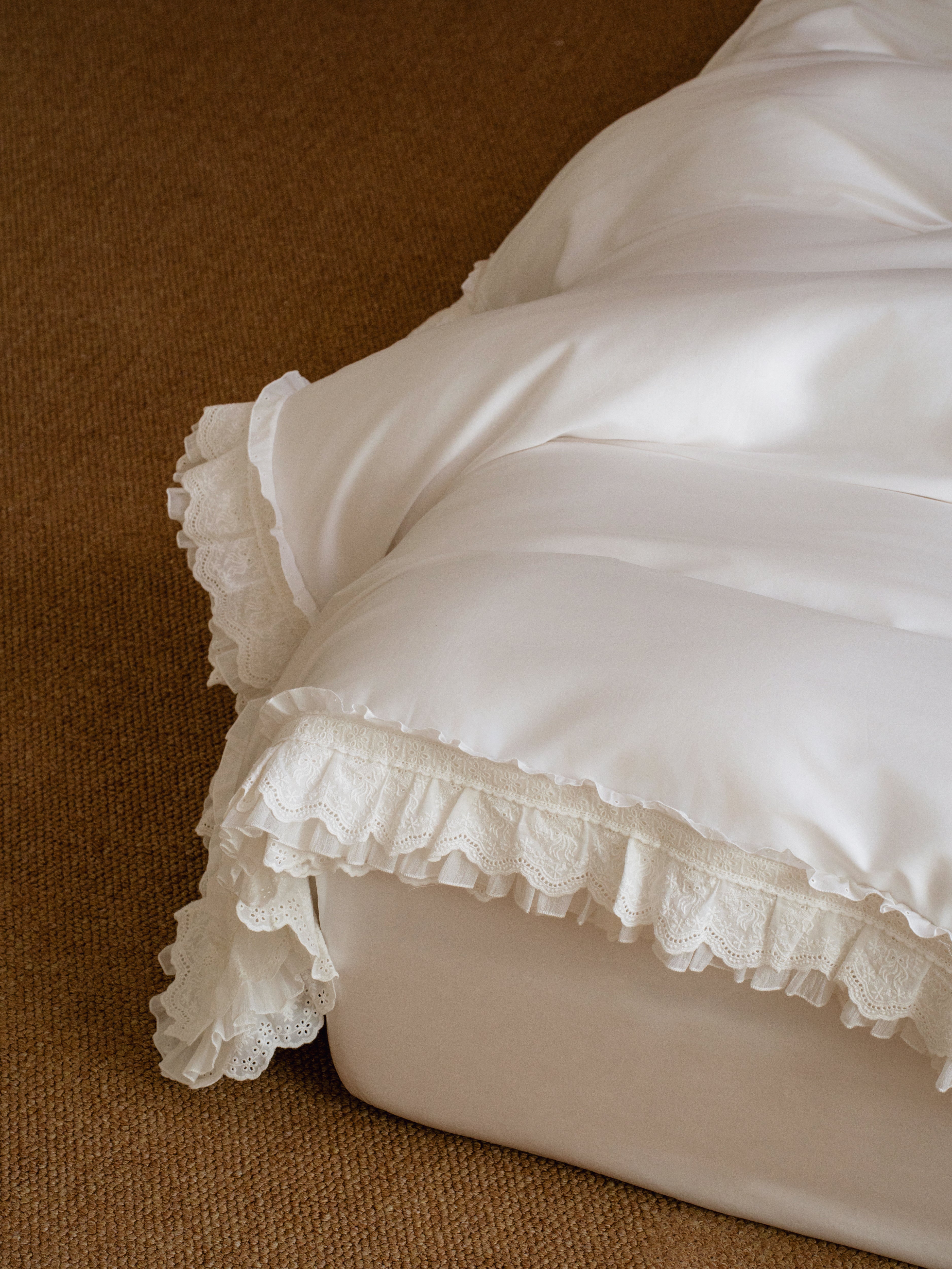 Close-up of layered ruffle edging on the Crème Egyptian cotton duvet cover