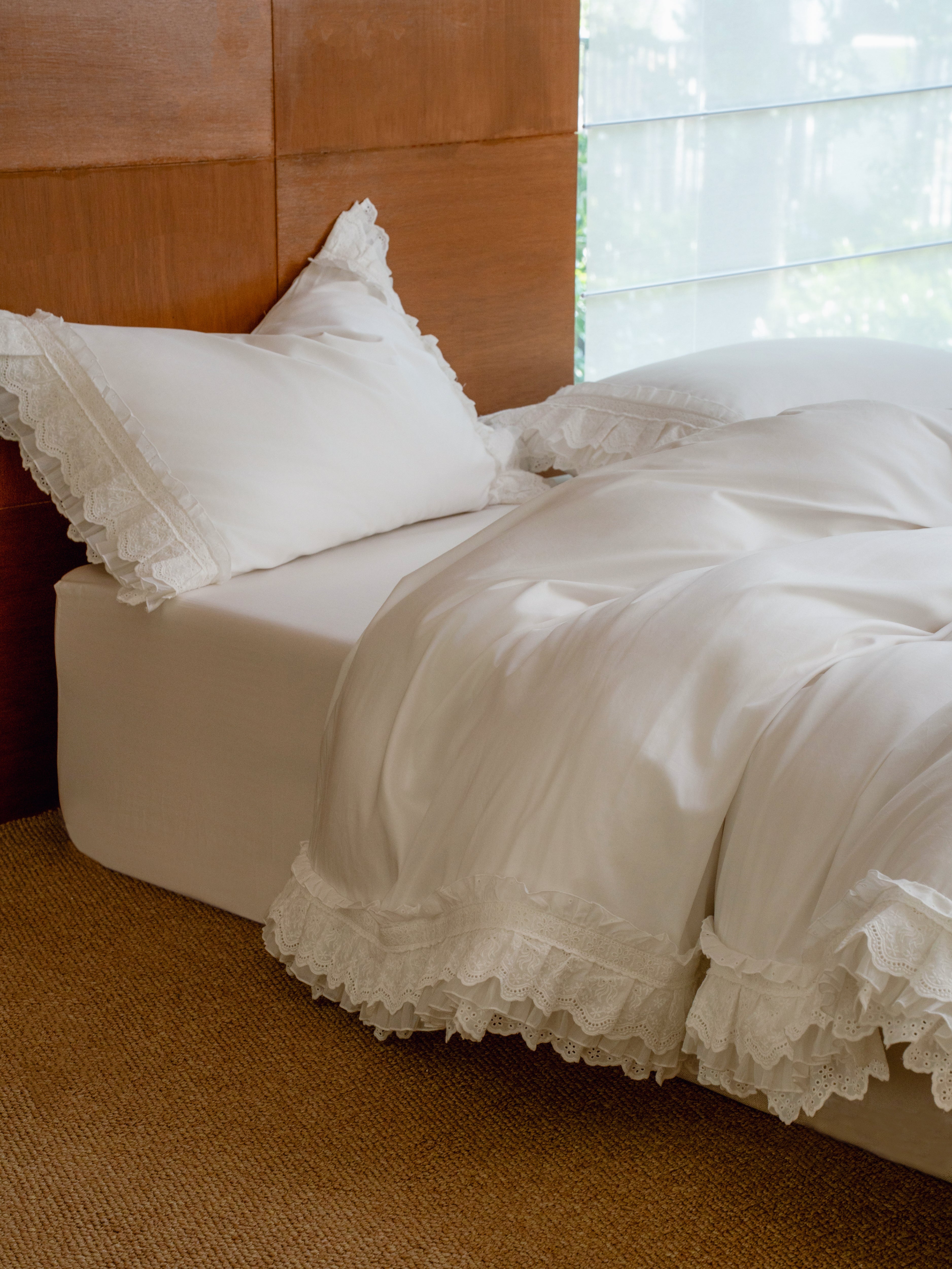 Crème layered ruffle duvet cover in ivory Egyptian cotton sateen on a styled bed