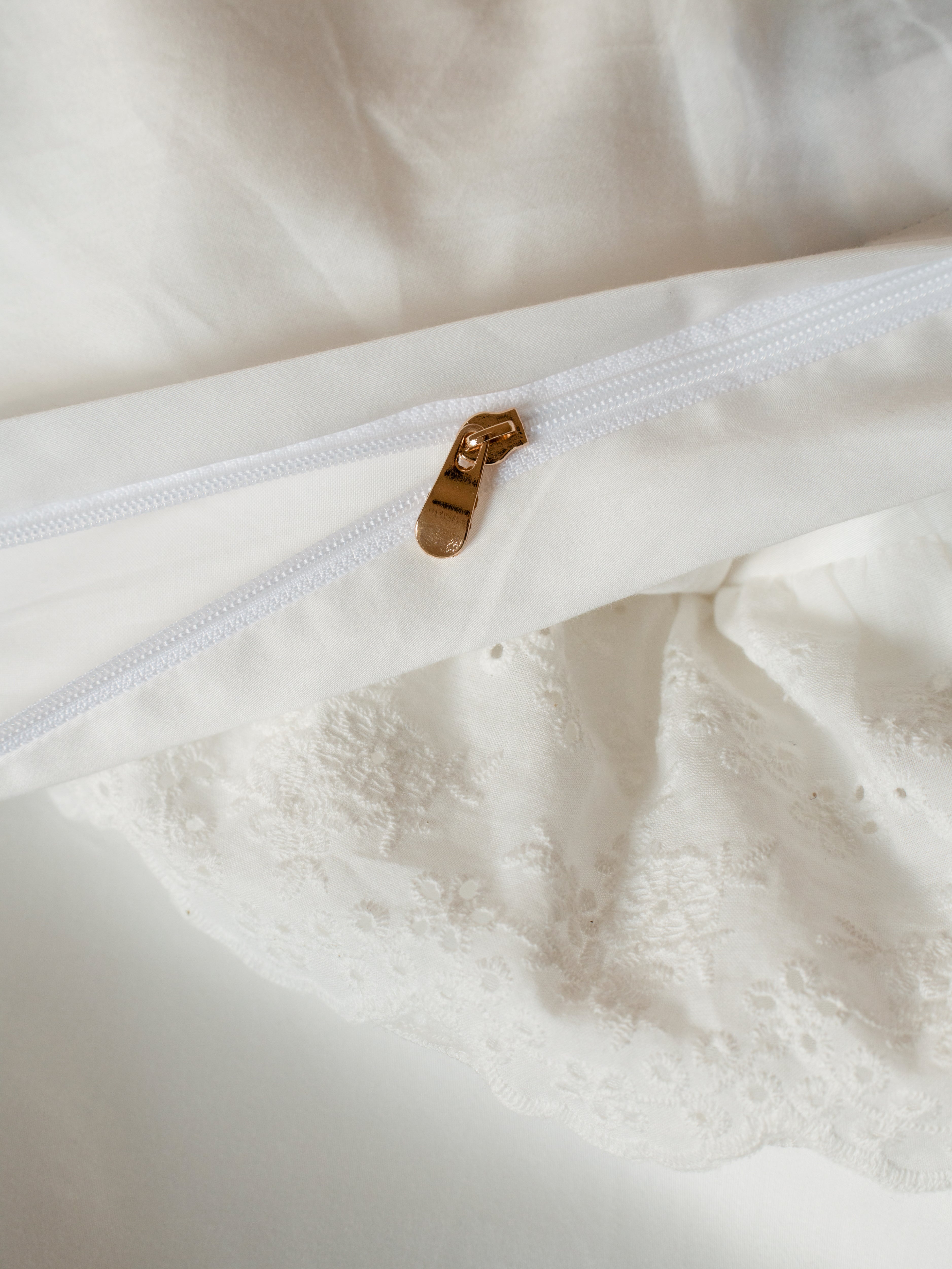 Hidden gold zipper closure on the Crème layered ruffle duvet cover