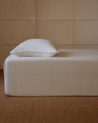 Lait deep pocket fitted sheet in ivory Egyptian cotton sateen on a mattress