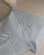 Two Laiterie Keepsake Bags in dusty blue cotton muslin with ribbon ties