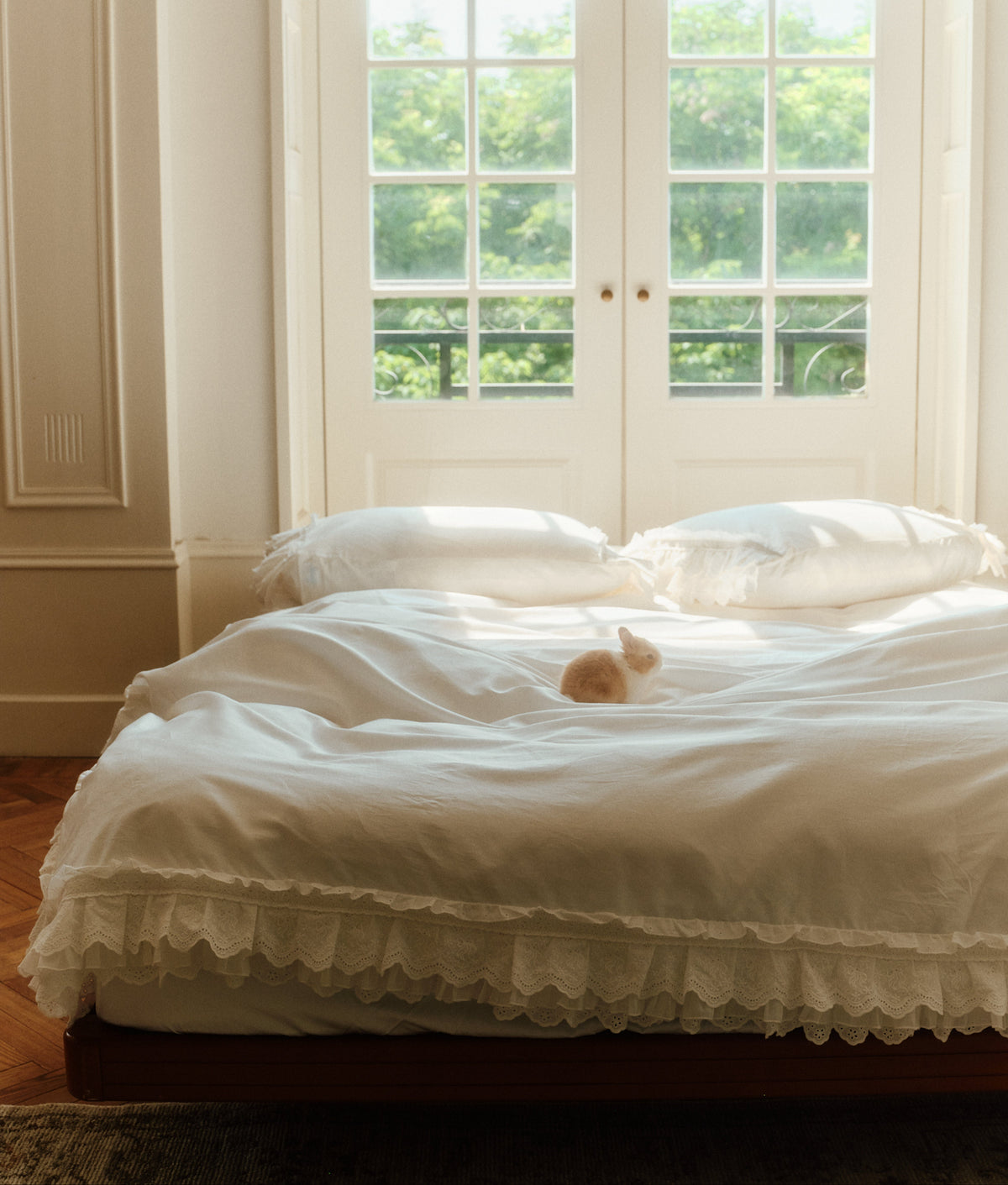 Laiterie Crème bedding set with layered ruffle duvet cover and matching pillowcases in a sunlit bedroom