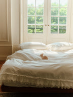 Crème layered ruffle bedding set styled in a bright bedroom