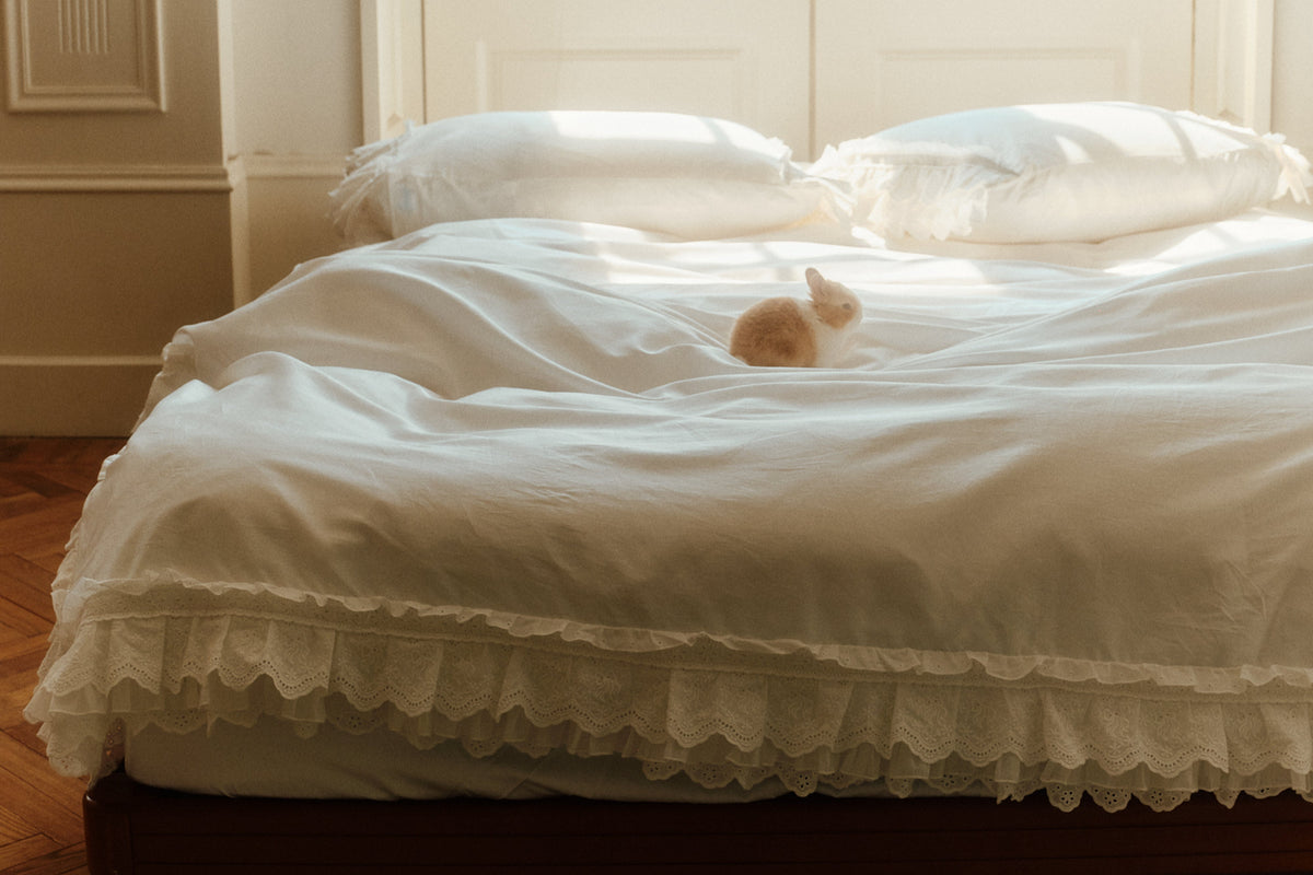 Laiterie Crème bedding set with layered ruffle duvet cover and matching pillowcases in a sunlit bedroom