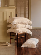 Stacked Chantilly and Crème ruffle pillowcases in ivory Egyptian cotton sateen
