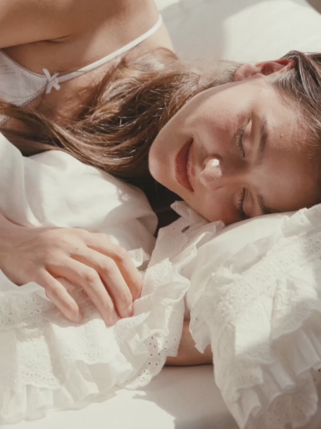 Woman resting on the Crème layered ruffle bedding set