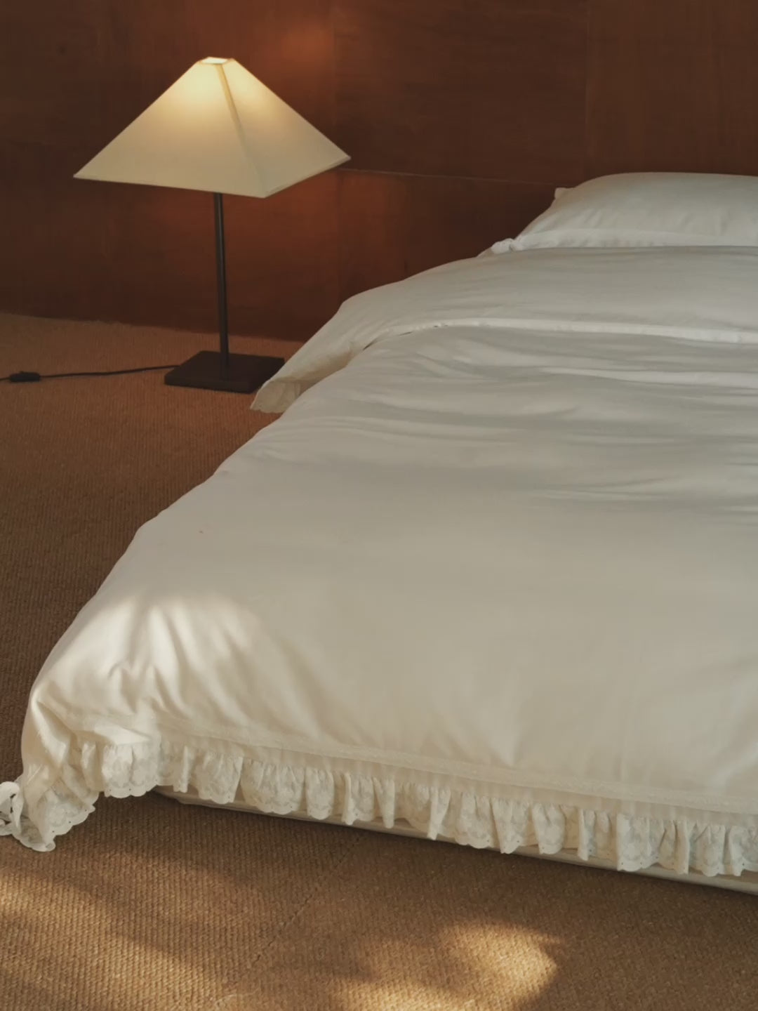Chantilly ruffle duvet cover draped over a bed with scalloped edging