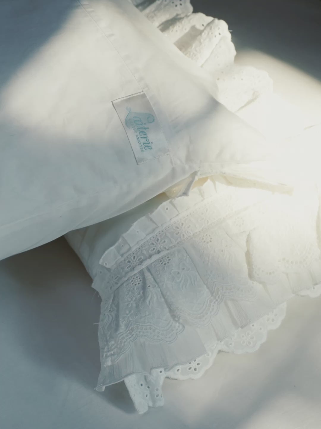 Crème pillowcase showing layered embroidered ruffles and sheer gauze detailing